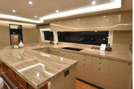 Slide: The Image of Luxurious kitchen interior on 2022 Horizon PC65 yacht with modern lighting and sleek countertops. - 52