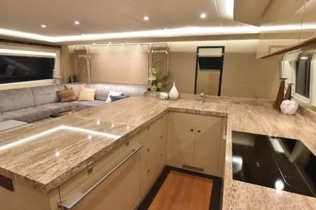 Slide: The Image of Luxurious 2022 Horizon PC65 yacht interior with modern kitchen and cozy seating area. - 55