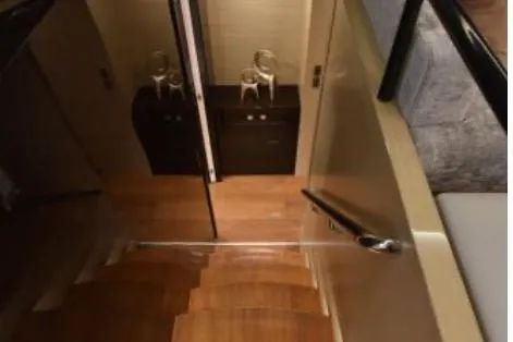 Slide: The Image of Staircase in 2022 Horizon PC65 yacht with wooden steps and elegant decor. - 64