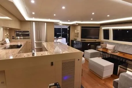 Slide: The Image of Luxurious interior of 2022 Horizon PC65 yacht with modern kitchen and seating area. - 71