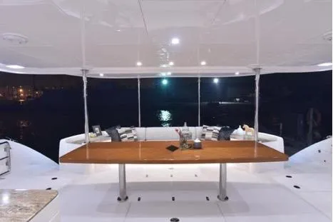 Slide: The Image of Luxurious Horizon PC65 yacht interior, featuring elegant seating and a polished wooden table, 2022 model. - 72