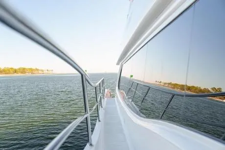 Slide: The Image of Side view of 2022 Horizon PC65 yacht cruising on open water. - 8