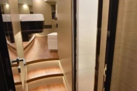 Slide: The Image of Luxurious interior of 2022 Horizon PC65 yacht, featuring elegant wooden steps and modern design. - 82