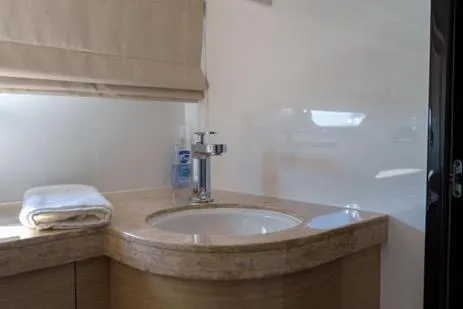 Slide: The Image of Modern bathroom sink in 2022 Horizon PC65 yacht with marble countertop and towel. - 90