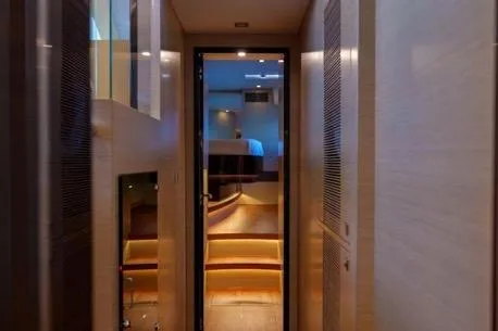 Slide: The Image of Luxurious interior hallway of 2022 Horizon PC65 yacht with ambient lighting. - 98