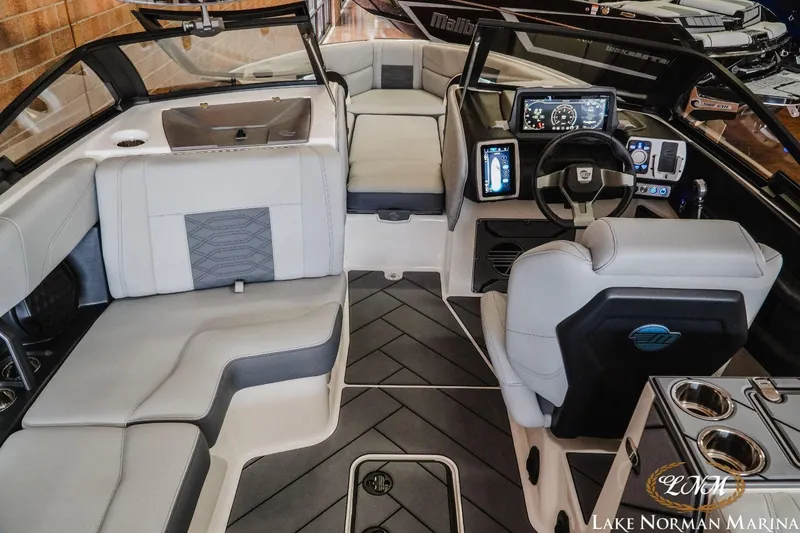 Slide: The Image of 2023 Malibu Wakesetter 25 LSV interior with modern dashboard and luxurious seating. - 12