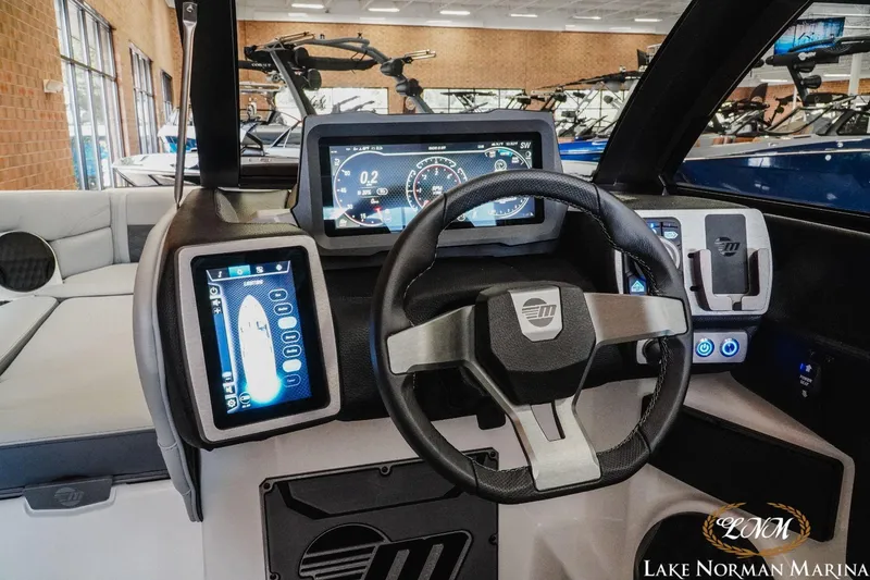 Slide: The Image of 2023 Malibu Wakesetter 25 LSV dashboard with advanced digital controls at Lake Norman Marina. - 13