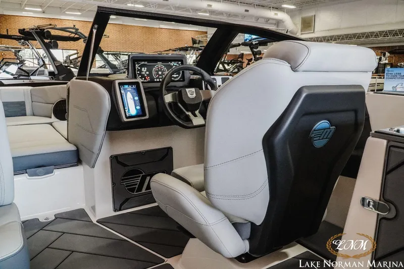 Slide: The Image of Interior of 2023 Malibu Wakesetter 25 LSV boat with modern dashboard and seating. - 14