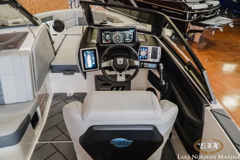 Slide: The Image of 2023 Malibu Wakesetter 25 LSV boat interior with advanced dashboard and seating at Lake Norman Marina. - 21