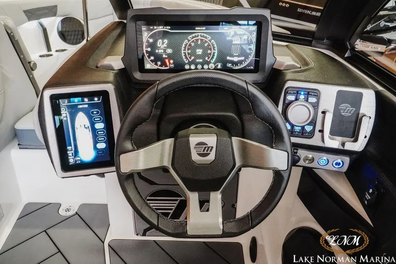Slide: The Image of 2023 Malibu Wakesetter 25 LSV dashboard with advanced digital controls and steering wheel. - 22