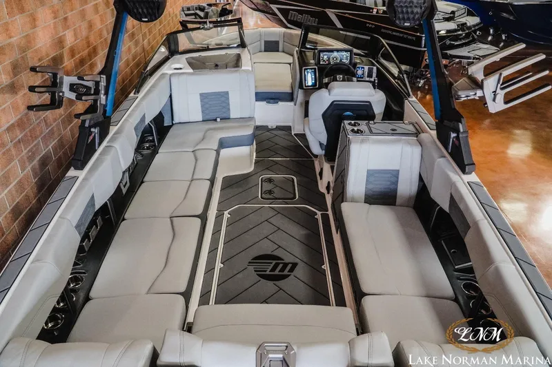 Slide: The Image of 2023 Malibu Wakesetter 25 LSV interior with spacious seating and modern dashboard at Lake Norman Marina. - 7