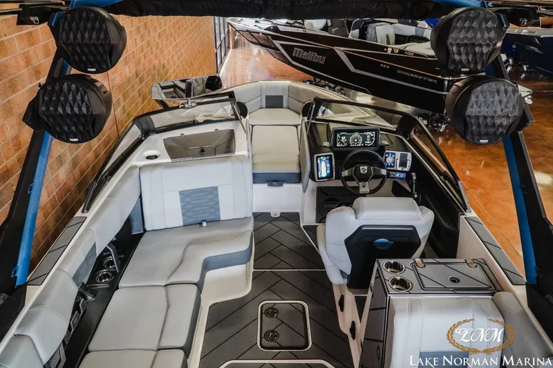 Slide: The Image of 2023 Malibu Wakesetter 25 LSV interior with modern dashboard and spacious seating at Lake Norman Marina. - 9