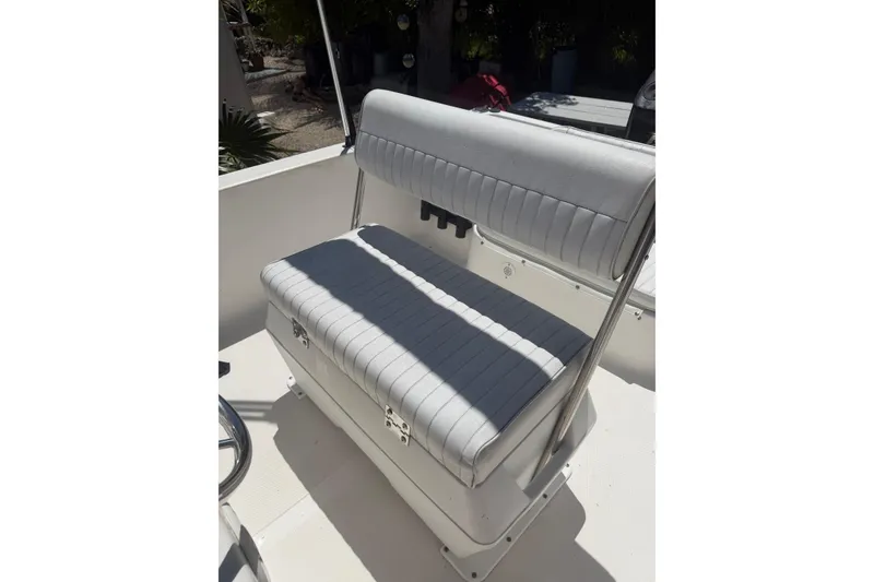 Slide: The Image of 2006 Sea Fox 187 Center Console boat seat with white cushioned upholstery. - 13
