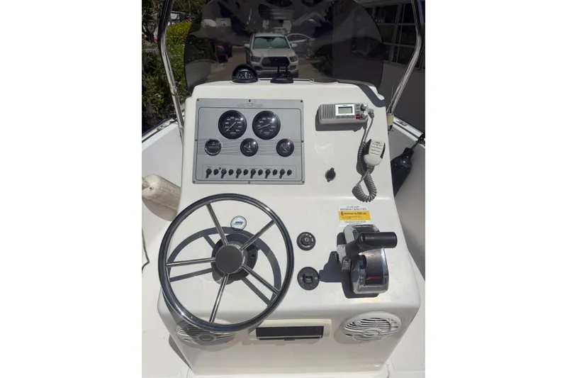Slide: The Image of Center console of a 2006 Sea Fox 187 boat with steering wheel and gauges. - 15