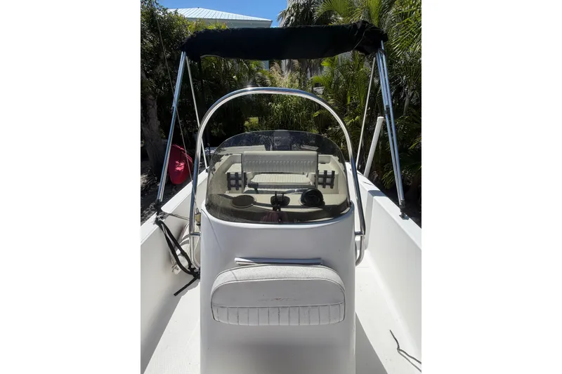 Slide: The Image of 2006 Sea Fox 187 Center Console boat with canopy, surrounded by lush greenery. - 18
