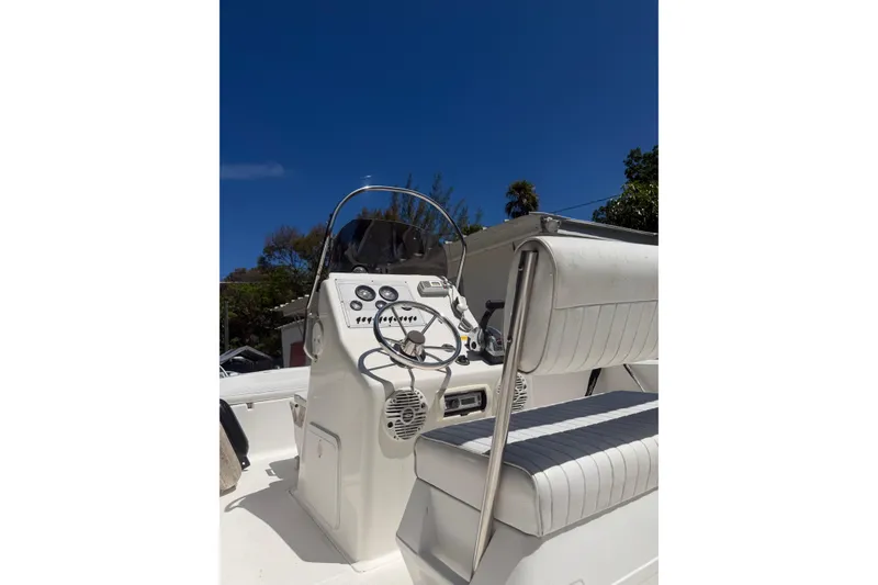 Slide: The Image of 2006 Sea Fox 187 Center Console boat interior with steering wheel and seating under clear blue sky. - 19