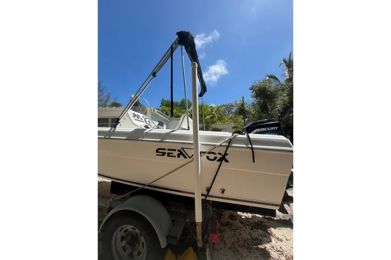 Slide: The Image of 2006 Sea Fox 187 Center Console boat on trailer under clear blue sky. - 4