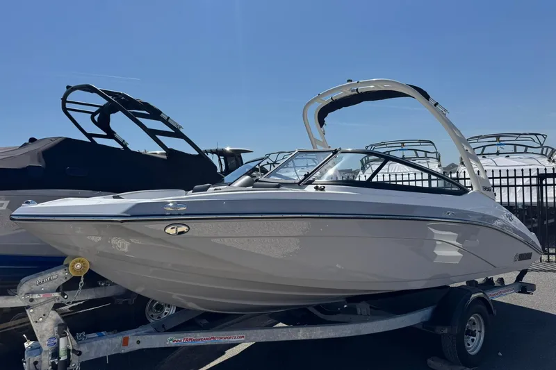 The Image of 2026 Yamaha Boats 195S on trailer, sleek design under clear blue sky. - 0