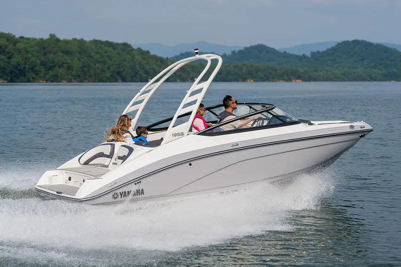 Slide: The Image of Manufacturer Provided Image: 2026 Yamaha Boats 195S cruising on a lake with passengers, surrounded by scenic hills. - 13
