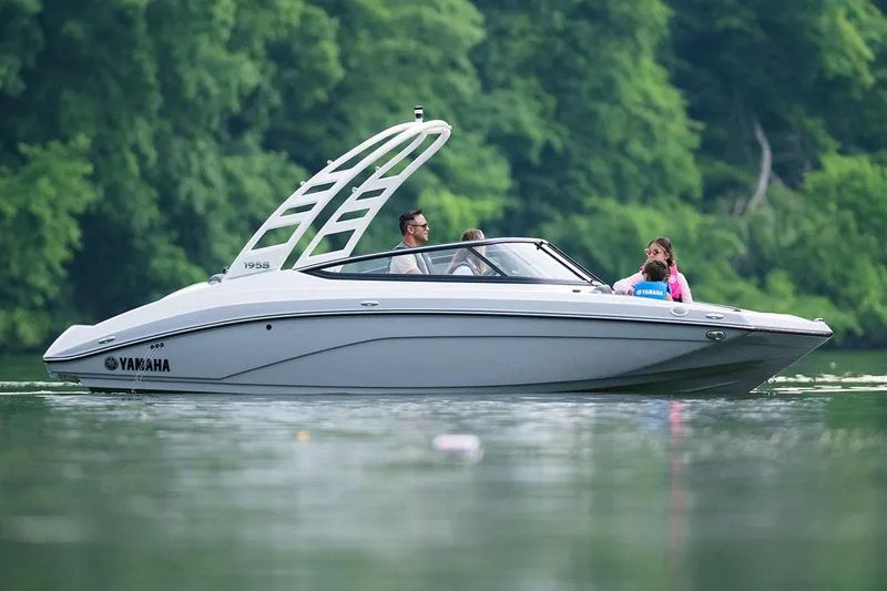 Slide: The Image of Manufacturer Provided Image: 2026 Yamaha Boats 195S on a serene lake with lush green background. - 14