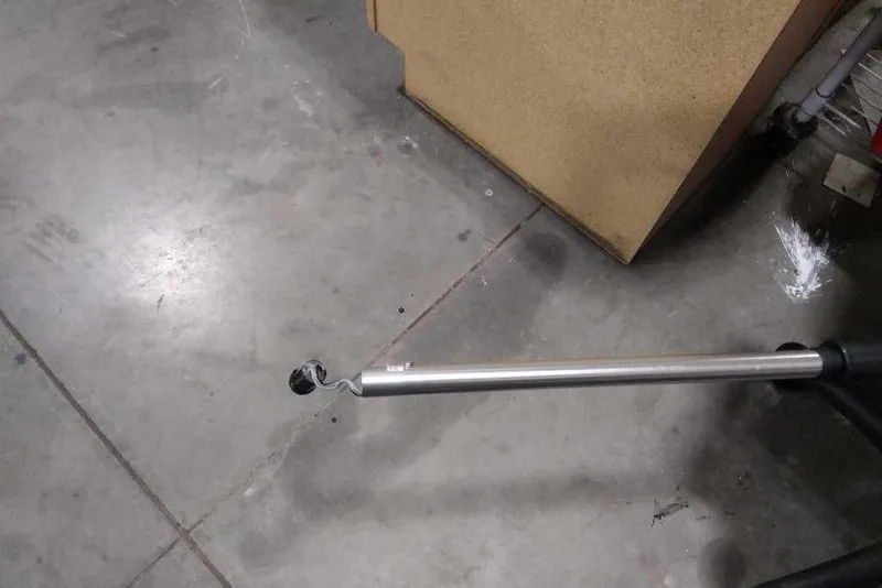 Slide: The Image of A metal pole with a small wheel on a concrete floor. - 50