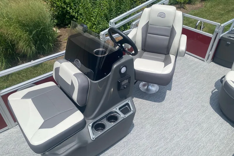 Slide: The Image of 2026 Sun Tracker Bass Buggy 18 DLX pontoon boat interior with captain's chair and console. - 5