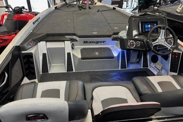 Slide: The Image of 2026 Ranger Z518 boat interior with modern dashboard and seating. - 13