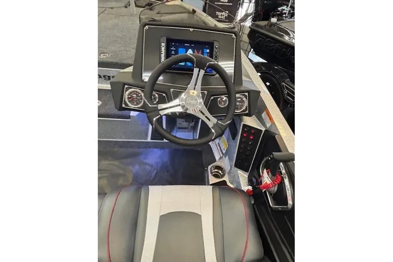 Slide: The Image of 2026 Ranger Z518 boat dashboard with steering wheel and modern controls. - 14