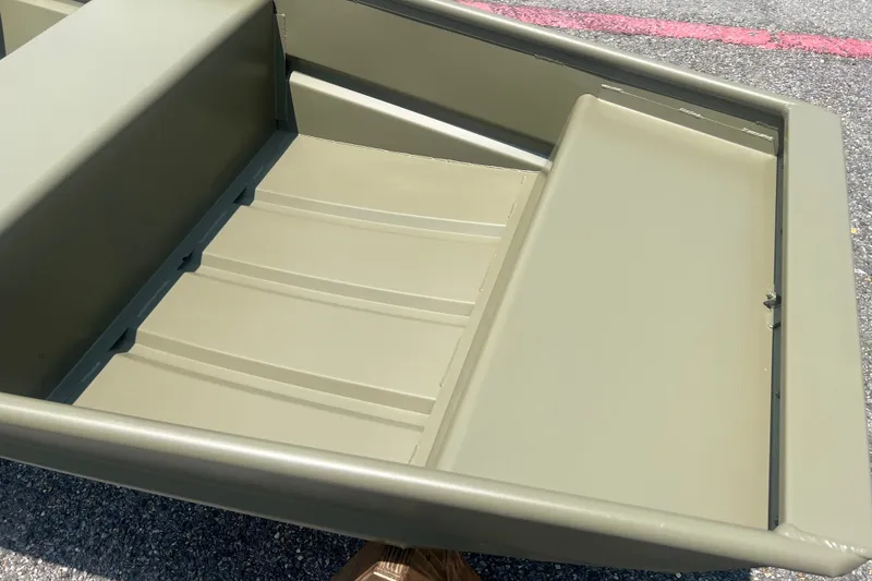 Slide: The Image of 2026 Tracker Grizzly 10 Jon boat interior, showcasing durable seating and flooring. - 6
