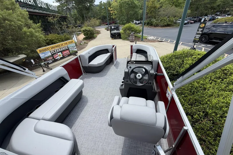 Slide: The Image of 2026 Sun Tracker Party Barge 16 DLX pontoon boat interior with seating and steering console. - 8