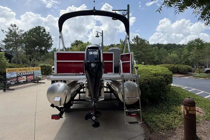 Slide: The Image of 2026 Sun Tracker Party Barge 16 DLX pontoon boat with 50 HP motor, parked outdoors. - 6