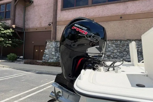 Slide: The Image of 2026 Mako Pro Skiff 19 CC with Mercury Pro XS outboard motor in a parking lot. - 4