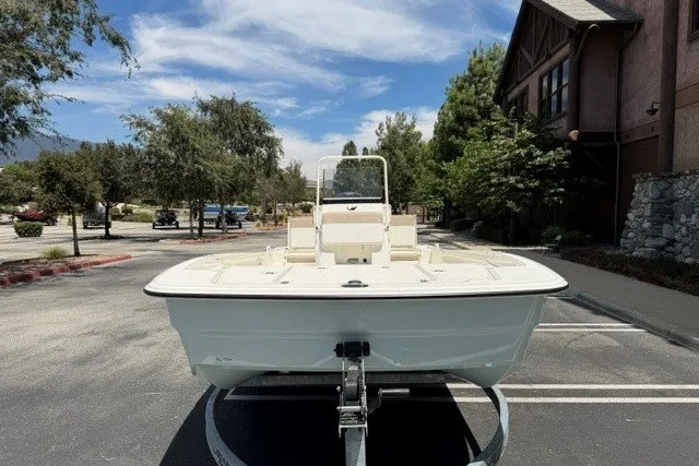 Slide: The Image of 2026 Mako Pro Skiff 19 CC boat on trailer in parking lot, sunny day. - 6