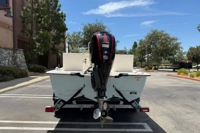 Slide: The Image of 2026 Mako Pro Skiff 19 CC boat on trailer, parked outdoors. - 3
