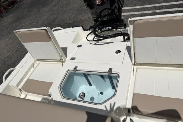 Slide: The Image of 2026 Mako Pro Skiff 19 CC boat interior with seating and storage compartments. - 8