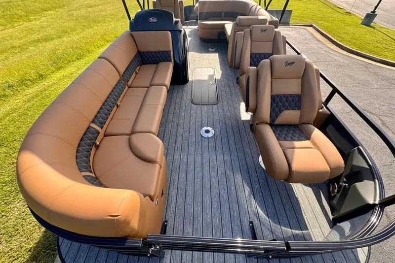 Slide: The Image of 2026 Ranger 223FC boat interior with tan and black seating, gray flooring, and spacious layout. - 15