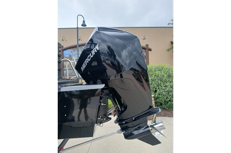 Slide: The Image of 2026 Ranger 223FC boat with Mercury outboard motor, parked outdoors. - 9
