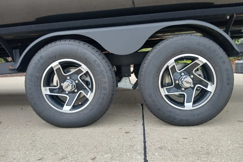Slide: The Image of Trailer wheels of a 2026 Ranger 223FC, featuring sleek black and silver rims. - 8