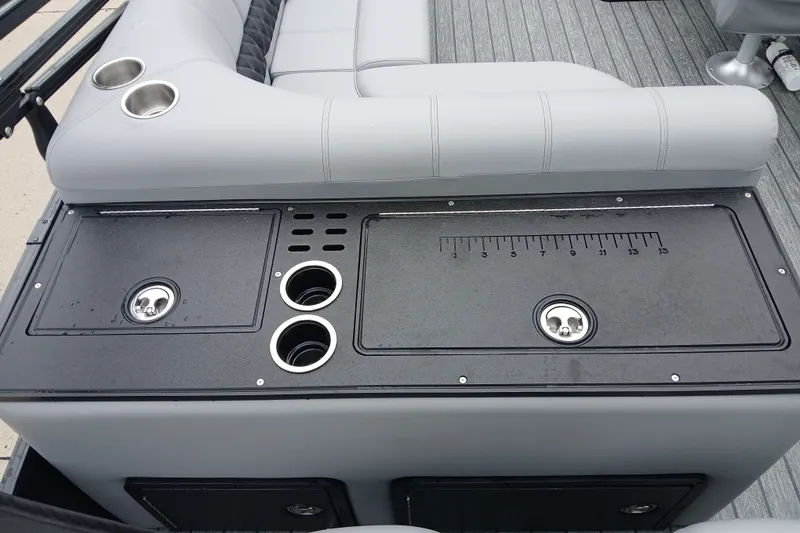Slide: The Image of 2026 Ranger 223FC boat interior with seating, cup holders, and storage compartments. - 6