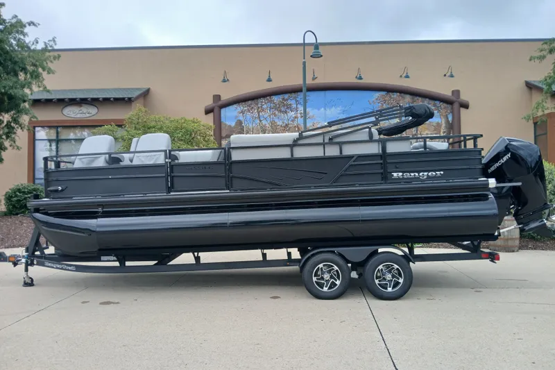 The Image of 2026 Ranger 223FC pontoon boat on trailer, parked outdoors. - 0