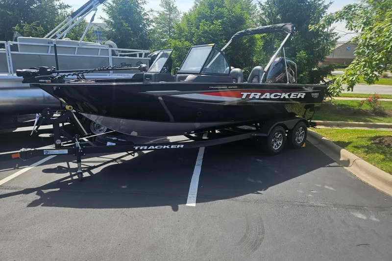 The Image of 2026 Tracker Targa V-19 Combo boat on trailer in parking lot, sunny day. - 0