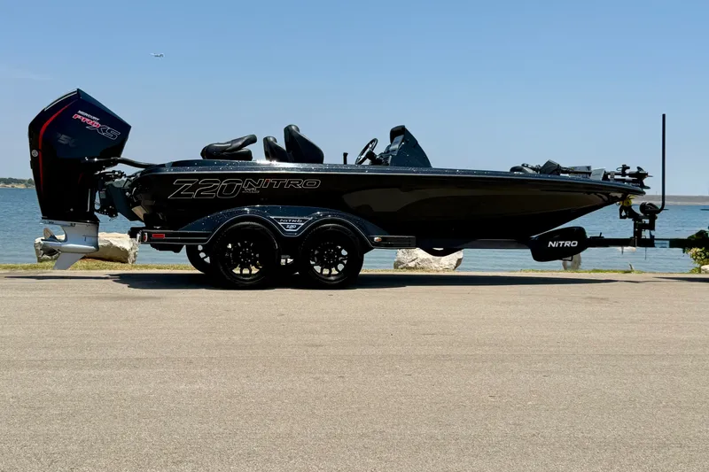 Slide: The Image of 2026 Nitro Z20 XL Pro boat on trailer by the water, showcasing sleek design. - 14