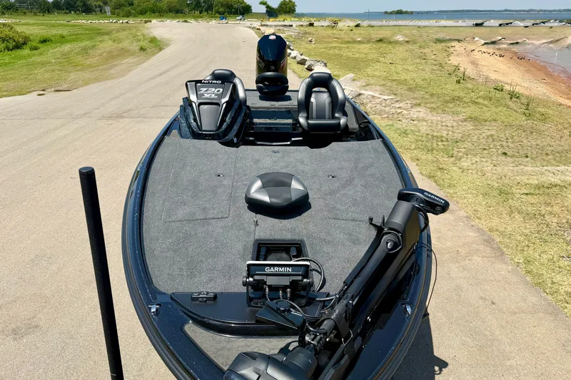 Slide: The Image of 2026 Nitro Z20 XL Pro fishing boat with Garmin equipment, parked near a lake. - 13