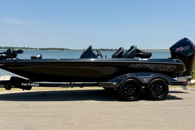 The Image of 2026 Nitro Z20 XL Pro boat by the water, showcasing sleek design and powerful engine. - 17