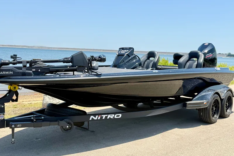 Slide: The Image of 2026 Nitro Z20 XL Pro boat on trailer by the water, showcasing sleek design. - 16