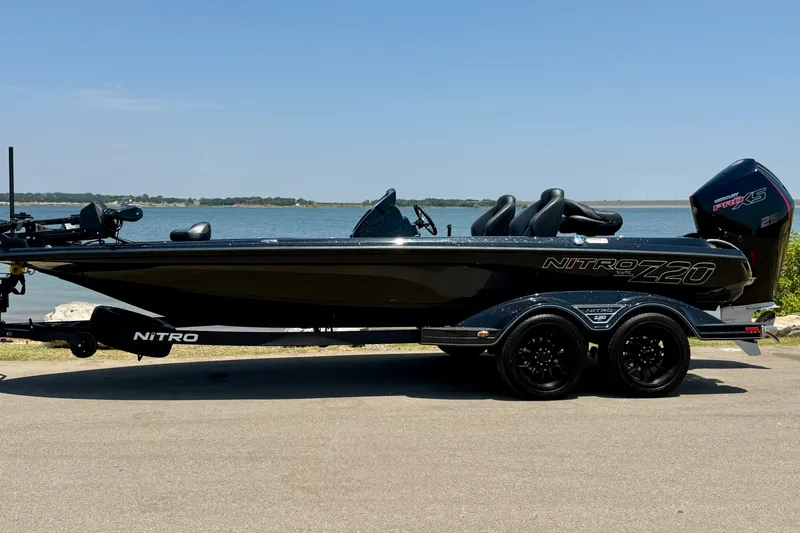 Slide: The Image of 2026 Nitro Z20 XL Pro boat on trailer by a lake, showcasing sleek design. - 18