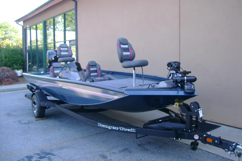 Slide: The Image of 2026 Ranger RT188P fishing boat on trailer, parked outside a building. - 1