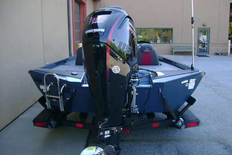 Slide: The Image of 2026 Ranger RT188P boat with Mercury 115 engine, parked outside a building. - 4