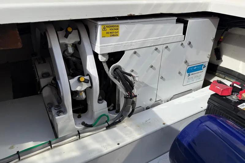 Slide: The Image of Engine compartment of a 2021 World Cat 400 DC-X boat, featuring electrical components and wiring. - 10