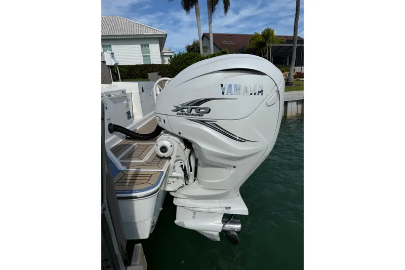 Slide: The Image of Yamaha XTO outboard motor on 2021 World Cat 400 DC-X boat, docked by waterfront homes. - 11